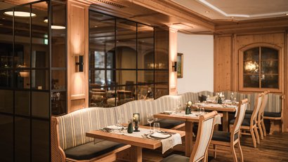 Gemütlicher Restaurantbereich mit Holzmöbeln und gedeckten Tischen