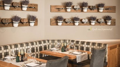 Cozy dining area with wooden furniture and lavender decorations on the wall