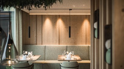 Modernes Restaurant mit Holzwänden und gedeckten Tischen mit Gläsern