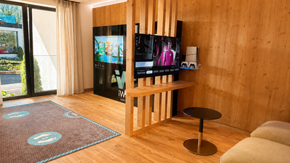 Moderner Aufenthaltsraum mit Fernseher, Spielekonsole und Sitzgelegenheiten