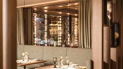 Modern restaurant with set tables and warm wood accents