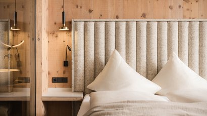 Modernes Schlafzimmer mit gestepptem Polsterkopfteil und zwei Kissen